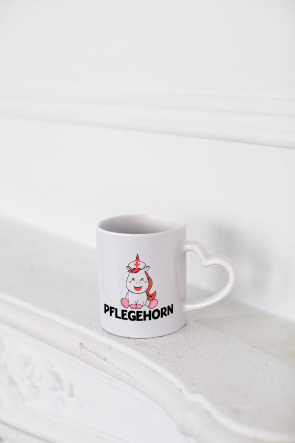 Pflegehorn | Krankenpflegerin | Einhorn - Herzhenkel Tasse - Kaffeetasse / Geschenk / Familie